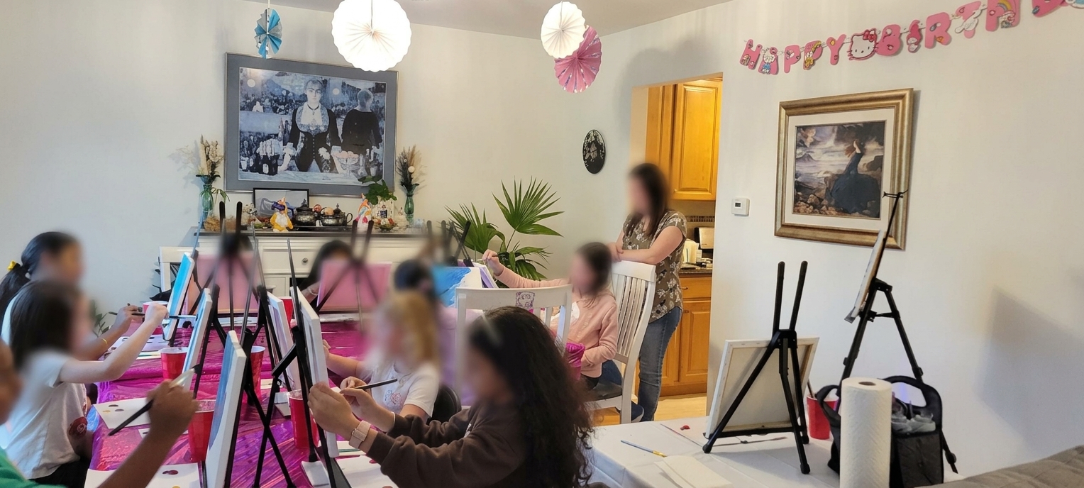 Guests painting together at a birthday table